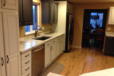 Example of a minimalist kitchen design in Denver with concrete countertops