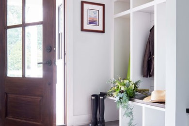 Design ideas for a mid-sized country mudroom in Richmond with white walls, a single front door, a dark wood front door, grey floor and porcelain floors.