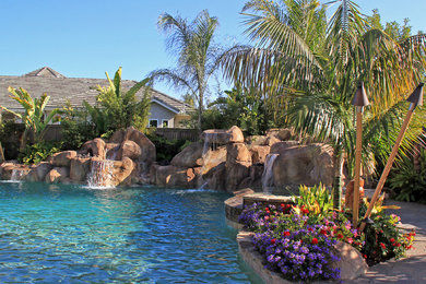 Mid-sized island style backyard custom-shaped natural pool fountain photo in San Diego