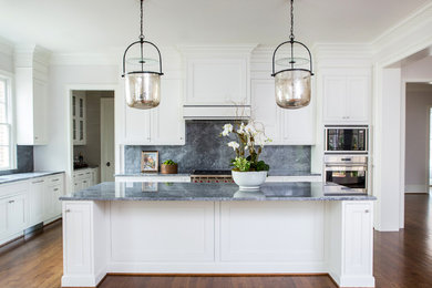 Inspiration for a large traditional l-shaped eat-in kitchen in Raleigh with an undermount sink, beaded inset cabinets, white cabinets, granite benchtops, grey splashback, stone slab splashback, stainless steel appliances, dark hardwood floors, with island, brown floor and grey benchtop.