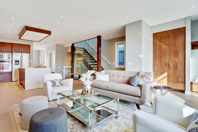 Family room - mid-sized contemporary open concept light wood floor family room idea in Calgary with white walls, no tv, a ribbon fireplace and a tile fireplace