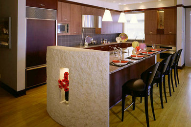 Kitchen - large contemporary l-shaped light wood floor and brown floor kitchen idea in Minneapolis with an island, flat-panel cabinets, medium tone wood cabinets, gray backsplash, ceramic backsplash and stainless steel appliances