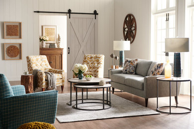 Example of a mid-sized farmhouse enclosed medium tone wood floor and brown floor family room design in Charlotte with white walls, no fireplace and no tv
