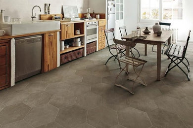 Inspiration for a transitional ceramic tile and gray floor kitchen remodel in Las Vegas with medium tone wood cabinets, wood countertops, white backsplash, stone tile backsplash and stainless steel appliances
