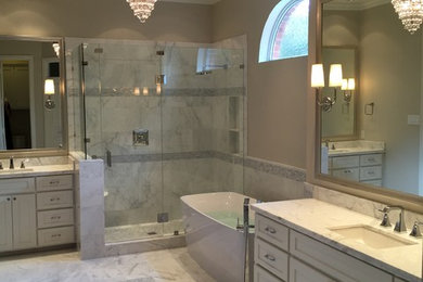 Inspiration for a large modern master white tile and stone tile marble floor bathroom remodel in Dallas with an undermount sink, shaker cabinets, white cabinets, marble countertops, a one-piece toilet and white walls