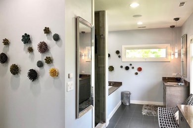 Example of a mid-sized mountain style master gray tile and ceramic tile porcelain tile and gray floor bathroom design in Tampa with gray walls, an undermount sink, a hinged shower door, black countertops, flat-panel cabinets and gray cabinets