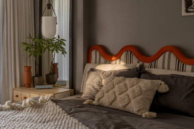 Example of a minimalist guest bedroom design in Pune with gray walls