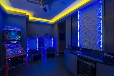 Example of a large minimalist porcelain tile and gray floor home bar design in Phoenix with an undermount sink, flat-panel cabinets, gray cabinets, granite countertops, black backsplash and stone slab backsplash