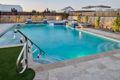 Large elegant backyard stone and l-shaped natural pool landscaping photo in Other