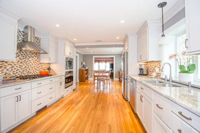 Farmhouse galley medium tone wood floor and brown floor eat-in kitchen photo in New York with a double-bowl sink, shaker cabinets, white cabinets, multicolored backsplash, mosaic tile backsplash, stainless steel appliances, no island and granite countertops