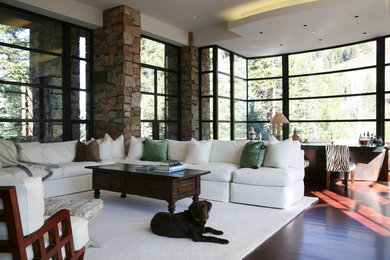 Minimalist medium tone wood floor living room photo in Denver with multicolored walls