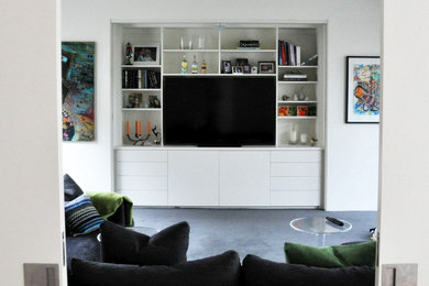 This is an example of a mid-sized contemporary open concept living room in Melbourne with white walls, carpet and a built-in media wall.