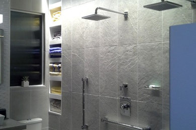 Doorless shower - small contemporary master gray tile and porcelain tile porcelain tile doorless shower idea in San Diego with a vessel sink, flat-panel cabinets, white cabinets, a two-piece toilet and white walls