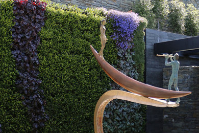 Inspiration for a small contemporary back formal partial sun garden in Sussex with a living wall.
