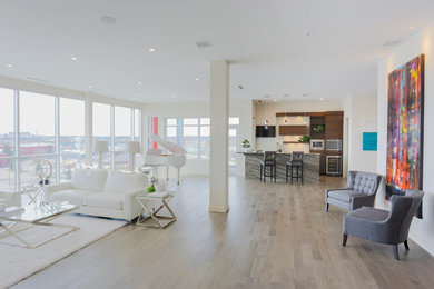 Example of a mid-sized trendy open concept porcelain tile living room design in Calgary with a bar, gray walls, a wood fireplace surround and a wall-mounted tv