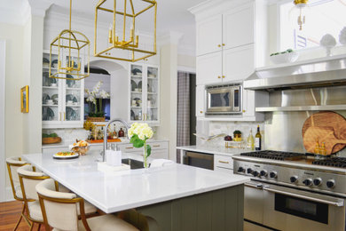 Kitchen - large traditional kitchen idea in Charleston with quartz countertops, white backsplash, marble backsplash, stainless steel appliances, an island and white countertops
