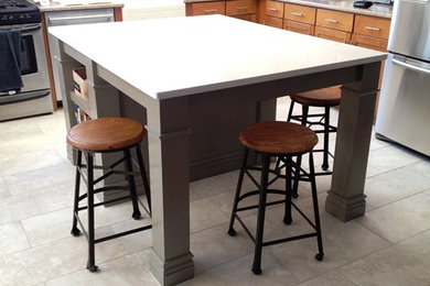 Eclectic u-shaped eat-in kitchen photo in Philadelphia with a farmhouse sink, shaker cabinets, quartz countertops, white backsplash, ceramic backsplash and stainless steel appliances