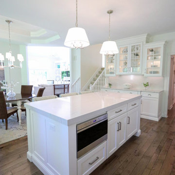 White Kitchen with Gray Quartz Countertops, Farmhouse Sink and Hardwood Floors