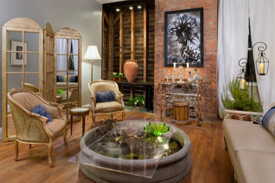 Mountain style brick wall living room photo in Other