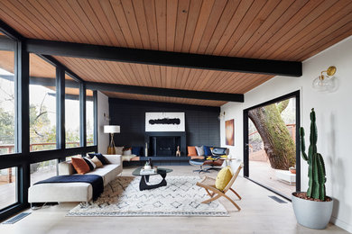 1960s light wood floor and beige floor living room photo in San Francisco with white walls and a standard fireplace