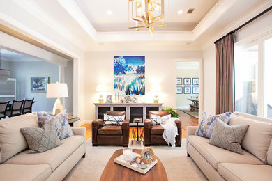 Inspiration for a mid-sized transitional open concept and formal medium tone wood floor and brown floor living room remodel in Atlanta with white walls, a tile fireplace, a standard fireplace and a wall-mounted tv