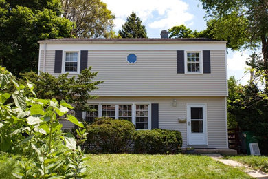 Mid-sized elegant beige two-story vinyl exterior home photo in Chicago with a shingle roof