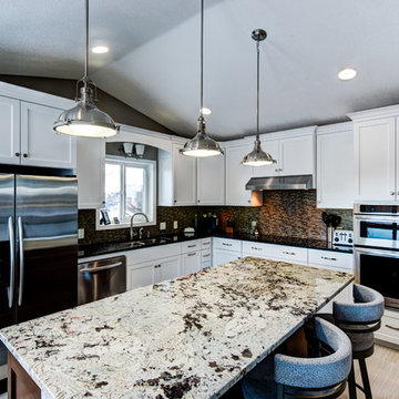 Painted cabinets with Alaska white granite on the island.