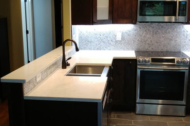 Example of a trendy kitchen design in Denver with metallic backsplash and wood backsplash