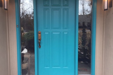 Single front door - coastal beige floor single front door idea in Chicago with beige walls and a blue front door