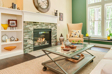 Example of a transitional family room design in Grand Rapids with a standard fireplace and a tile fireplace
