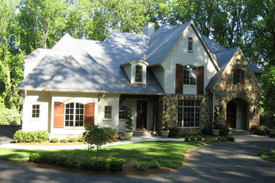 Arts and crafts beige three-story stucco exterior home photo in DC Metro