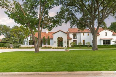 Mediterranean white two-story stucco house exterior idea in Dallas with a tile roof