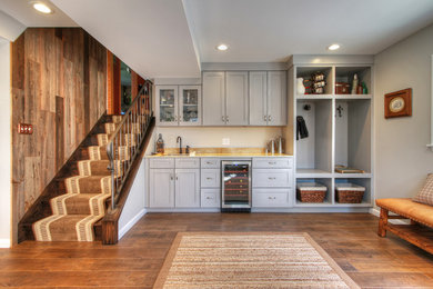Example of a huge trendy walk-out medium tone wood floor basement design in St Louis with beige walls