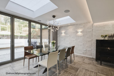 Minimalist porcelain tile and gray floor great room photo in Hertfordshire with gray walls