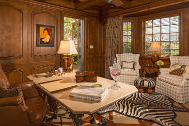 Home office - large freestanding desk home office idea in Santa Barbara with a standard fireplace