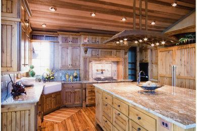 Mid-sized mountain style l-shaped light wood floor and beige floor enclosed kitchen photo in Other with a farmhouse sink, light wood cabinets, granite countertops, beige backsplash, porcelain backsplash, paneled appliances and an island