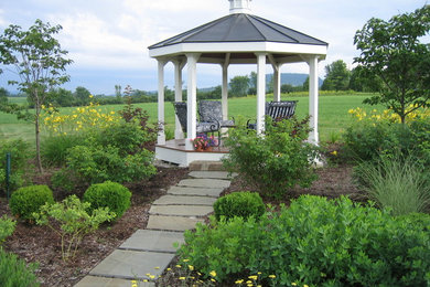 Patio - large traditional backyard stone patio idea in Burlington with a gazebo