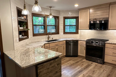 Mid-sized elegant u-shaped medium tone wood floor and brown floor eat-in kitchen photo in Minneapolis with an undermount sink, flat-panel cabinets, light wood cabinets, granite countertops, beige backsplash, ceramic backsplash, stainless steel appliances, a peninsula and beige countertops