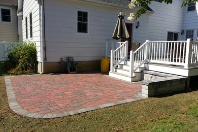 Small traditional backyard patio in Baltimore with brick pavers and no cover.