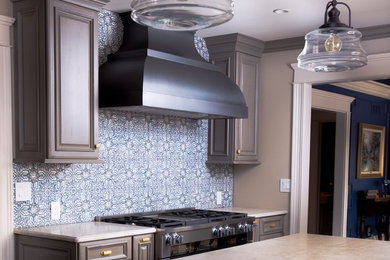 Mid-sized single-wall kitchen photo in Chicago with blue backsplash, ceramic backsplash and stainless steel appliances