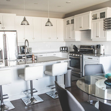 View of the kitchen with a large kitchen island and seating area from the eating