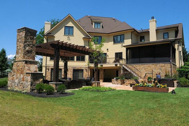 Inspiration for a large timeless beige two-story mixed siding exterior home remodel in DC Metro with a hip roof