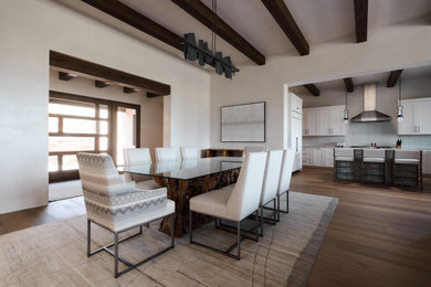 Inspiration for a large southwestern medium tone wood floor, brown floor and exposed beam great room remodel in Albuquerque with beige walls