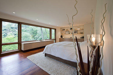 Photo of a modern bedroom in Philadelphia with white walls and medium hardwood floors.