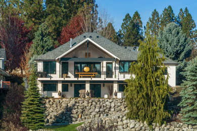 Example of a mid-sized trendy white two-story concrete fiberboard exterior home design in Other with a shingle roof and a black roof