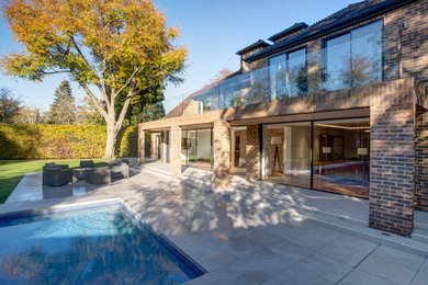 Inspiration for a contemporary brown house exterior in Surrey.