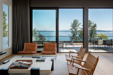 Mid-sized minimalist open concept light wood floor living room photo in Seattle with white walls