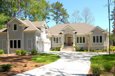 This is an example of a large traditional two-storey grey house exterior in Atlanta with mixed siding, a gable roof and a shingle roof.