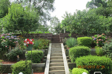 This is an example of a large traditional backyard concrete paver retaining wall landscape in Baltimore.