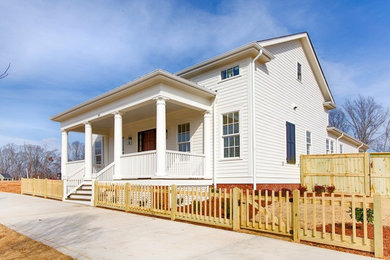 Mid-sized elegant white two-story concrete fiberboard gable roof photo in Other